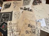 a lot of drawings on a table with pictures on it