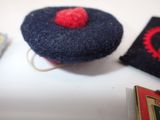 a small blue hat with a red heart on top of it