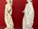 three statues that are on display on a red surface
