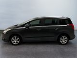 the small black van is parked in a room with a gray floor