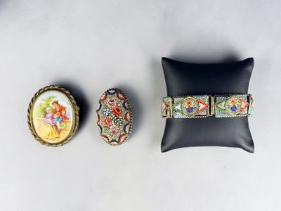 three pieces of jewelry sitting on top of a black pillow