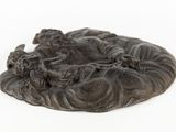 a small statue of a group of animals on a plate