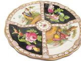 a decorative plate with birds and flowers on it