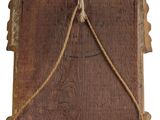 a picture of a wooden plaque hanging on a wall