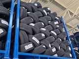a lot of tires stacked on a rack in a warehouse