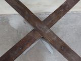 an image of a wooden cross on a cement floor