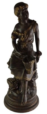 bronze statue of a woman with a basket and a dog