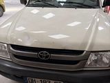 a white toyota pickup truck parked in a garage