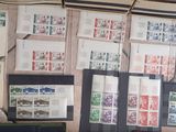 a desk with a computer and a bunch of stamps on the wall