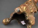 a bronze object with a dog on it on a table