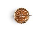 an image of a gold brooch or pin with a circular design