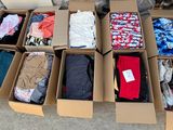 many boxes of clothes that are sitting on the ground