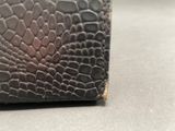 a close up of a wallet with a snake skin pattern on it