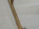 a wooden object that is laying on a white surface