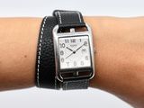 someone is wearing a watch on their wrist with a leather band
