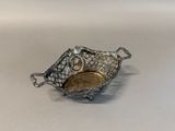 an image of a silver plate with a fish design on it