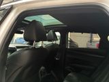 a silver car with a black leather seat in the back of it