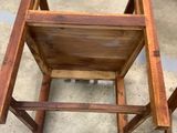 a wooden chair that is sitting on the floor
