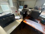 a desk with a printer and a printer on it