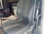 a seat in the back of a van with a bag in it