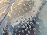 a close up of a glass with bubbles in it