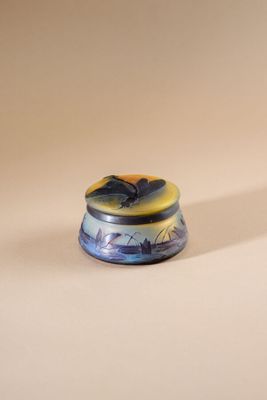 a small blue and yellow object on a white surface