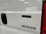 the back end of a white truck with the word boxer written on it
