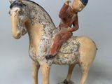 a figurine of a man sitting on a horse