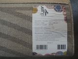 a label on the back of a couch that says it is made of jute