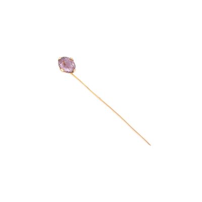 un gros plan sur un bâton orné d'une pierre violette