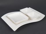 a white plate with two bowls on it on a black table