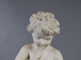 a statue of a boy with a flower in his hand