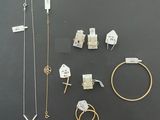 many different types of jewelry on display on the table
