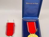 an image of a medal and a medal in a blue box