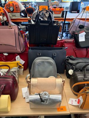 a lot of purses on a table in a store