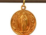 a close up of a gold medal on a string