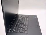 a laptop with a black keyboard on a white surface