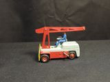 a toy fire truck with a man sitting on top of it