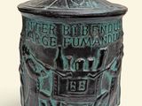 une petite boîte en bronze surmontée d'un oiseau