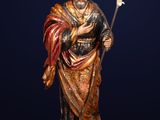 an image of a statue of a man holding a staff