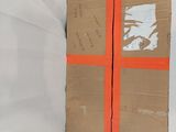 a cardboard box that has been wrapped in orange tape