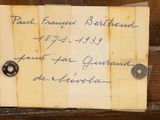 an old piece of paper with writing on it sitting on top of a wooden table
