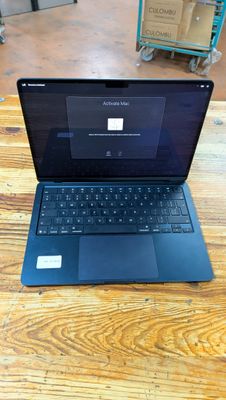 a laptop that is sitting on a wooden table
