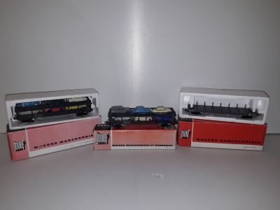 several toy trains are lined up in a row on a table