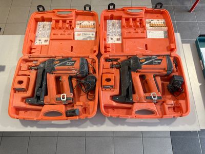 deux outils orange dans un coffret posé sur une table