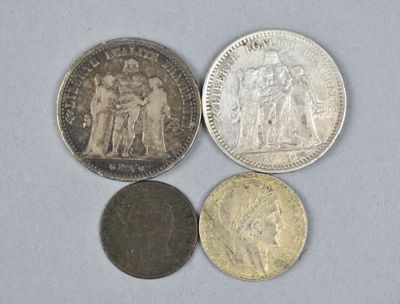 four different types of coins sitting on top of a white surface