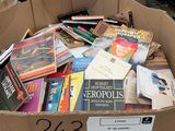 a cardboard box full of books in the middle of a room