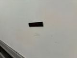 a sticker on the side of a refrigerator in a kitchen