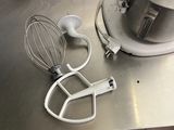 a mixer and a whisk on the counter