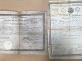 an old document sitting on top of a cardboard box next to a pair of scissors